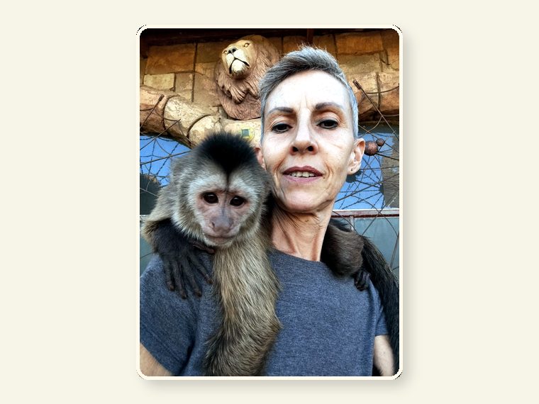 Marlene with a rescued capuchin in sanctuary care